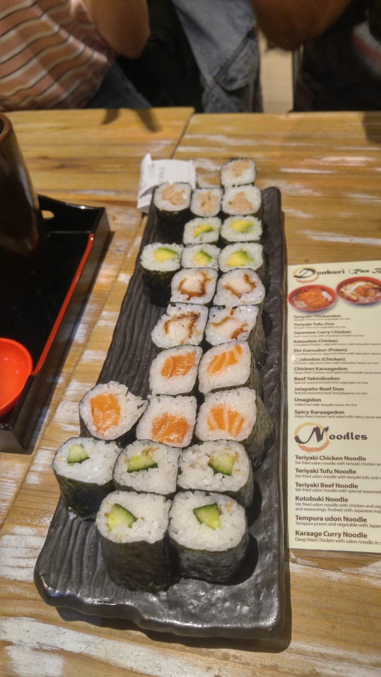Sushi wird in mundgerechten Stücken optisch ansprechend zubereitet serviert